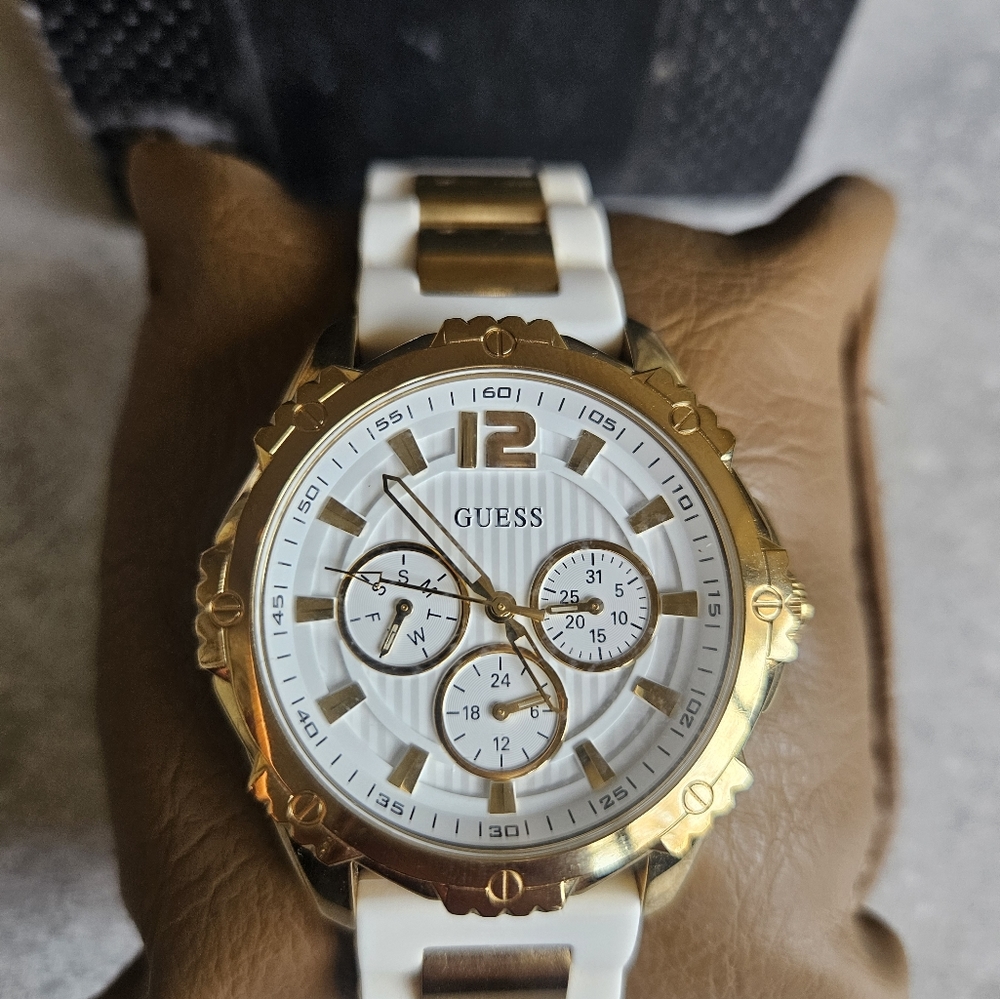 Elegent Woman Guess gold watch with white strap